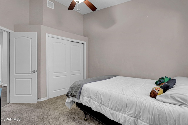 bedroom with a closet, carpet floors, and ceiling fan