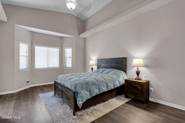 bedroom featuring vaulted ceiling and dark hardwood / wood-style flooring