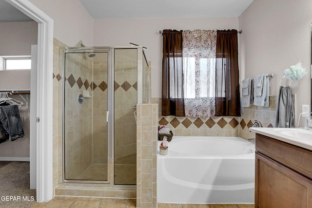 bathroom with vanity, shower with separate bathtub, and tile patterned flooring