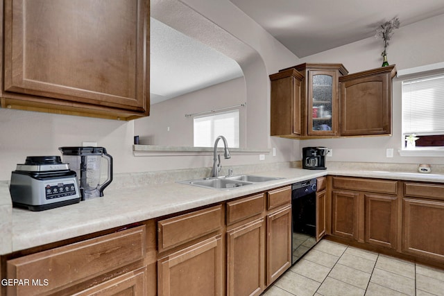 kitchen featuring black dishwasher, sink, and light tile patterned floors