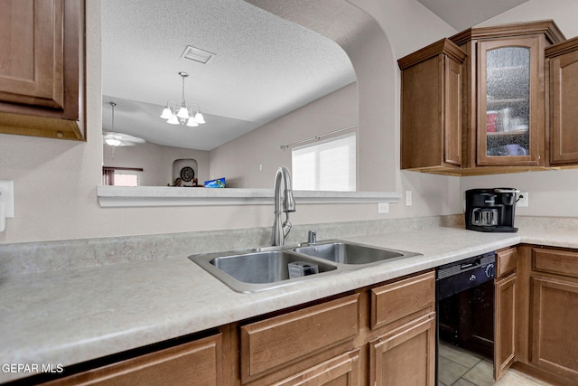 kitchen featuring sink, dishwasher, lofted ceiling, light tile patterned floors, and an inviting chandelier