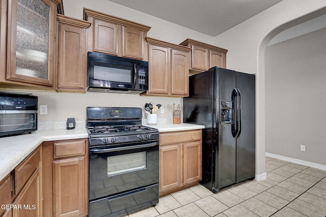 kitchen with black appliances and light tile patterned floors