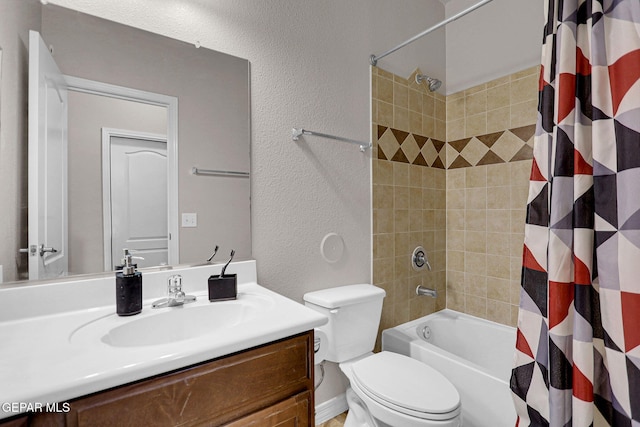 full bathroom with vanity, shower / tub combo, and toilet