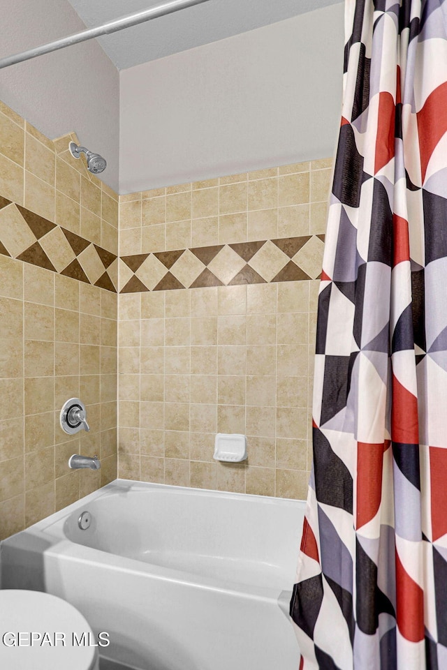 bathroom with toilet and shower / bath combo with shower curtain