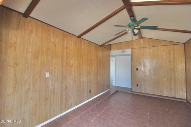 unfurnished room featuring ceiling fan, wooden walls, and vaulted ceiling with beams