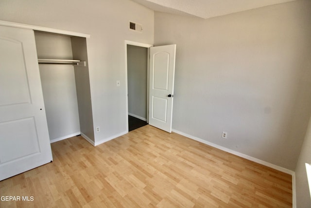 unfurnished bedroom with a closet and light hardwood / wood-style flooring