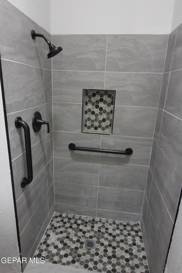 bathroom with a tile shower