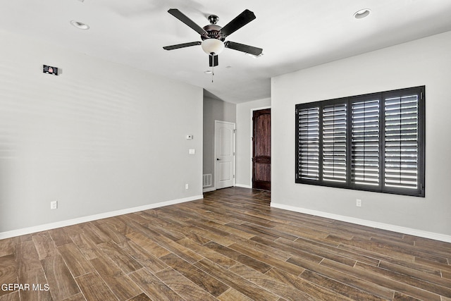 unfurnished room featuring ceiling fan and dark wood-type flooring