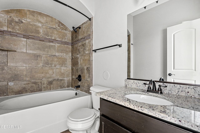 full bathroom with vanity, toilet, and tiled shower / bath combo