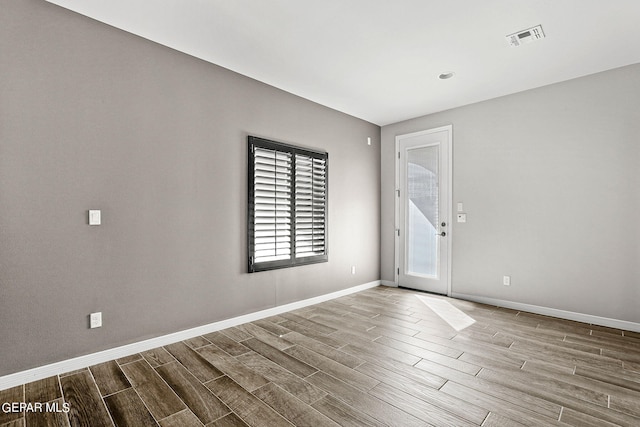 unfurnished room featuring wood-type flooring