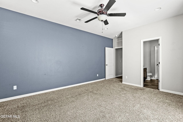 unfurnished bedroom featuring ceiling fan, ensuite bath, and carpet