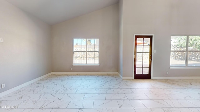 unfurnished room with high vaulted ceiling and a healthy amount of sunlight