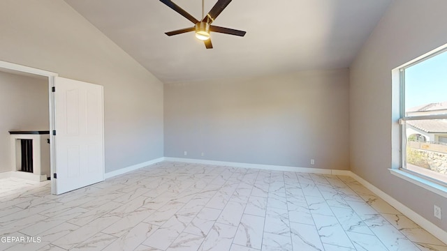 spare room with ceiling fan and vaulted ceiling