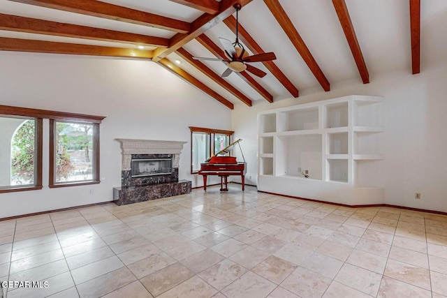 unfurnished living room with beam ceiling, a premium fireplace, light tile patterned floors, high vaulted ceiling, and ceiling fan