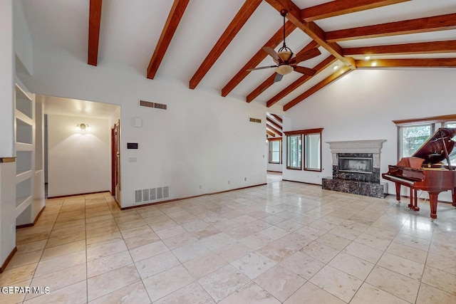 unfurnished living room featuring beamed ceiling, a premium fireplace, light tile patterned floors, high vaulted ceiling, and ceiling fan