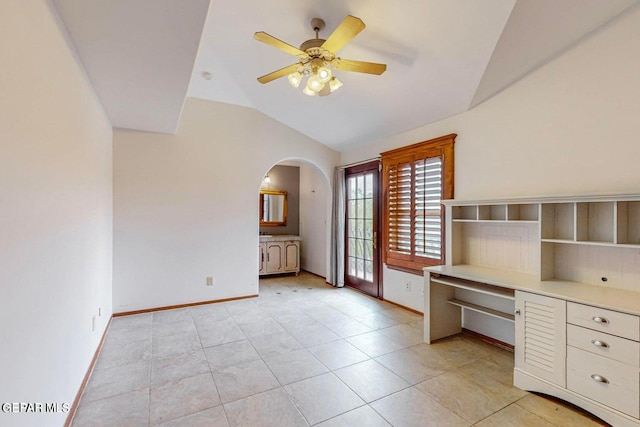 unfurnished office with lofted ceiling, light tile patterned floors, and ceiling fan