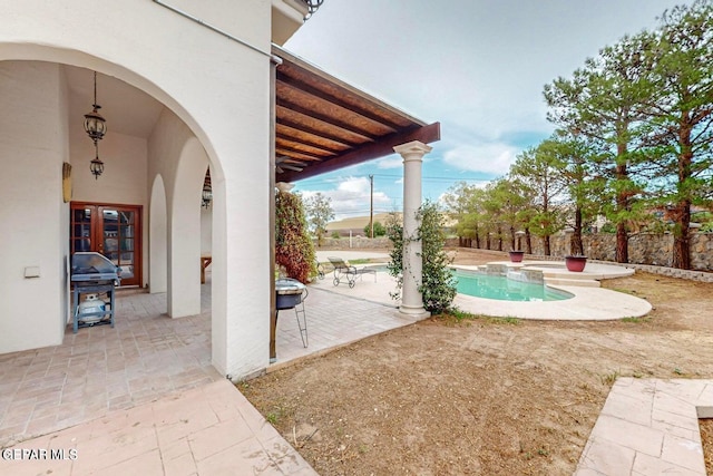 view of patio / terrace featuring a grill and a fenced in pool