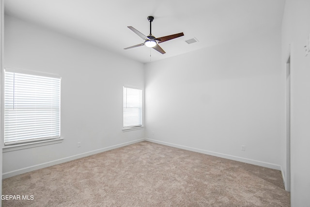 carpeted spare room with ceiling fan