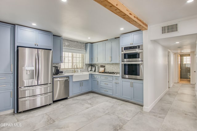 kitchen with crown molding, appliances with stainless steel finishes, sink, backsplash, and beam ceiling