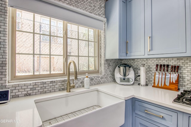 interior space with decorative backsplash and sink