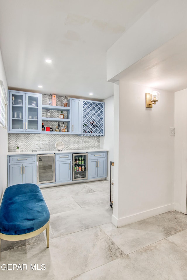 bar featuring wine cooler and backsplash