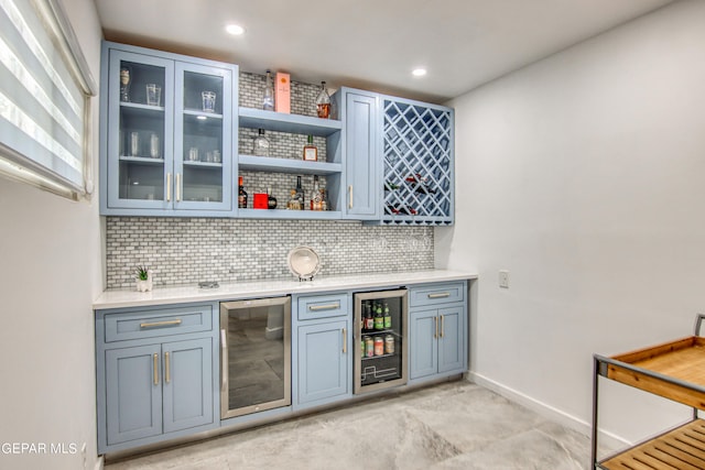 bar featuring backsplash and beverage cooler