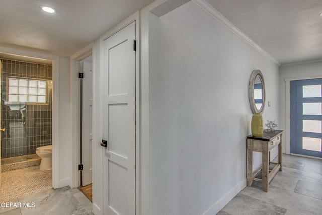 interior space featuring ornamental molding and light tile patterned flooring