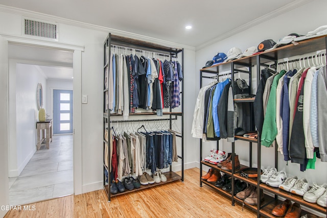 spacious closet featuring light hardwood / wood-style flooring