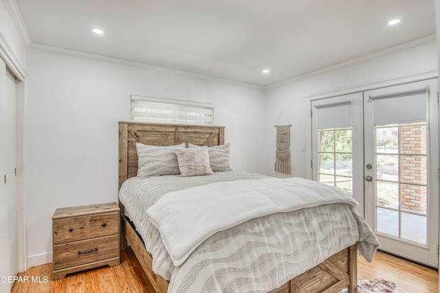 bedroom featuring a closet, access to outside, wood-type flooring, and french doors