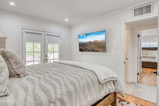 bedroom with french doors, crown molding, wood-type flooring, and access to exterior