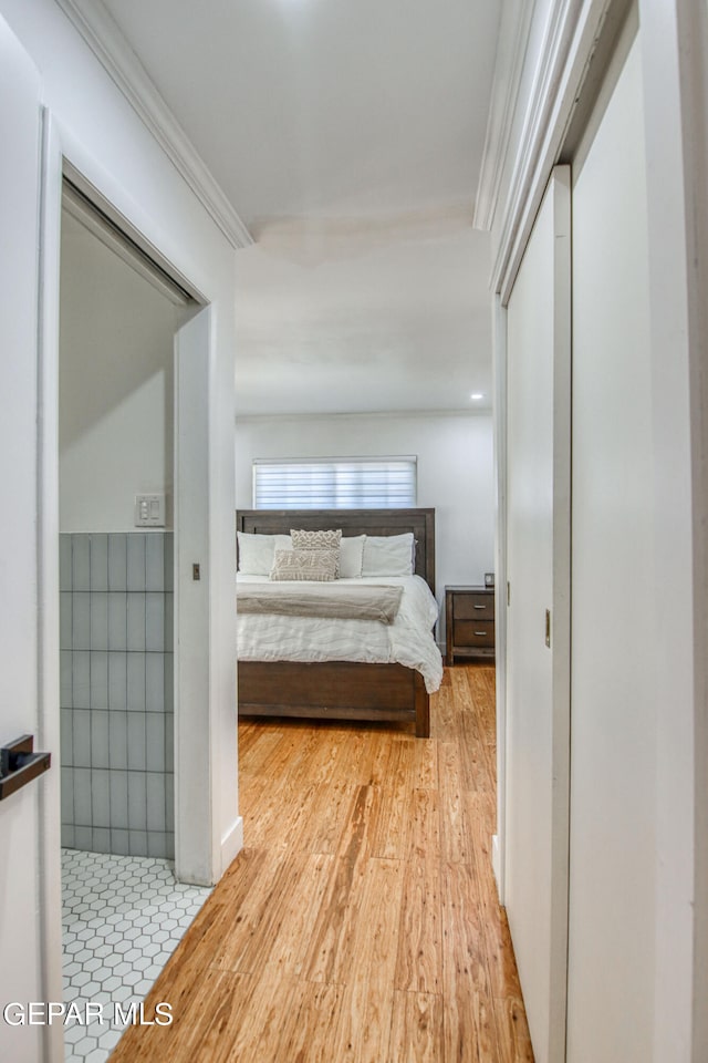 bedroom featuring ornamental molding, a closet, and hardwood / wood-style floors