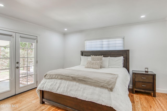 bedroom featuring french doors, light hardwood / wood-style flooring, crown molding, and access to outside