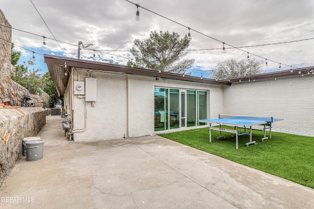 back of house featuring a patio area and a yard