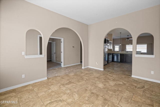 unfurnished room featuring ceiling fan