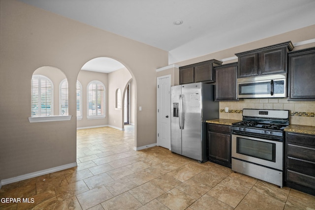 kitchen featuring tasteful backsplash, appliances with stainless steel finishes, and dark brown cabinetry