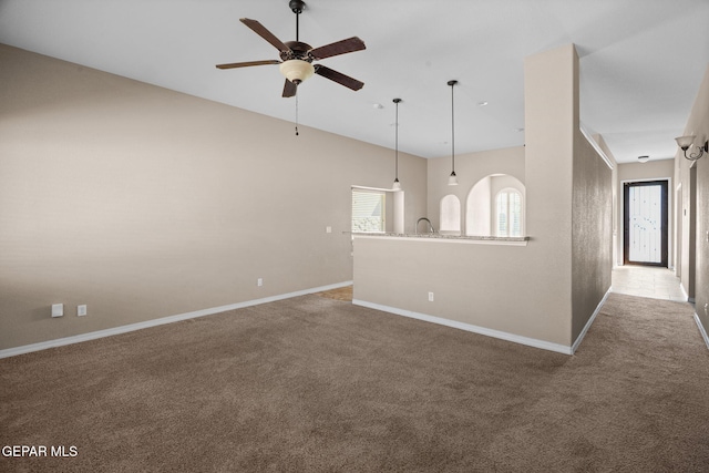 spare room with carpet and ceiling fan