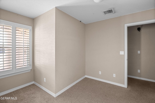 unfurnished room with carpet floors