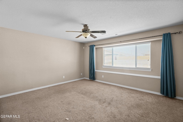 spare room featuring a textured ceiling, carpet flooring, and ceiling fan