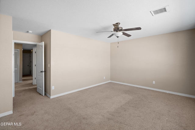 carpeted spare room with ceiling fan and a textured ceiling