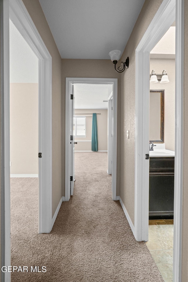 hall featuring light colored carpet