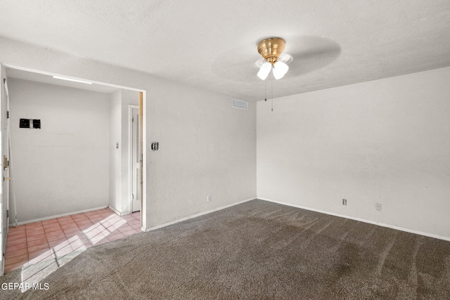 carpeted empty room featuring a textured ceiling and ceiling fan