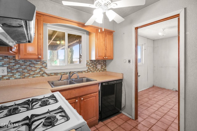 kitchen featuring black dishwasher, sink, a textured ceiling, gas range gas stove, and decorative backsplash