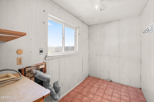 unfurnished room with a textured ceiling