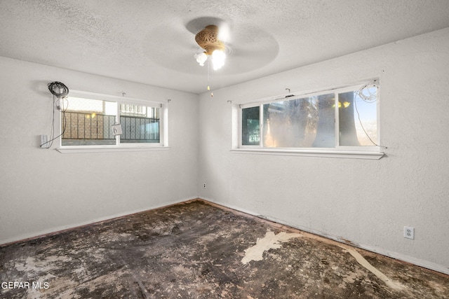 empty room featuring a textured ceiling and ceiling fan