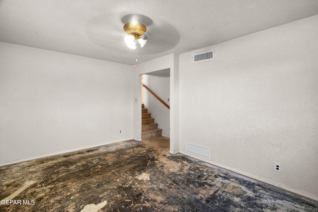 spare room with a textured ceiling and ceiling fan