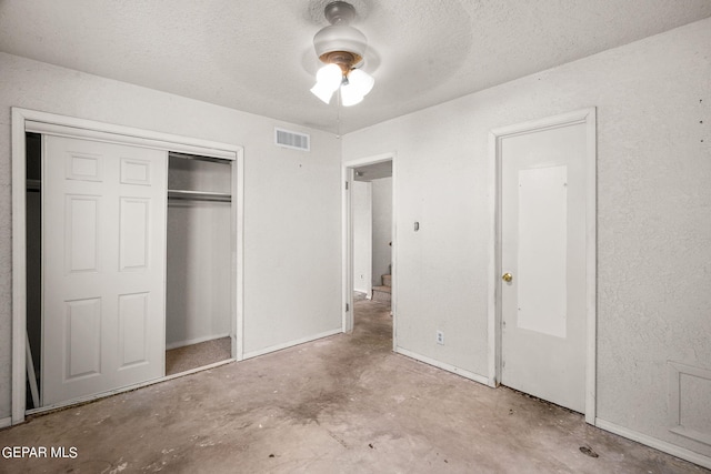 5797 Port Lavaca Dr, El Paso, TX 79924 - unfurnished bedroom featuring unfinished concrete floors, a closet, a textured ceiling, a ceiling fan, and baseboards