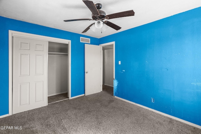 unfurnished bedroom with a closet, ceiling fan, and dark carpet