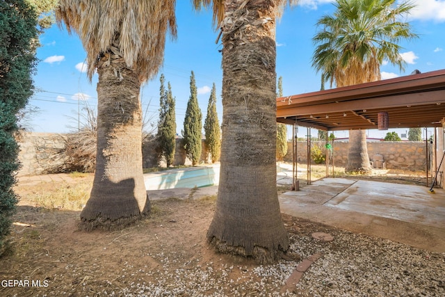 view of yard with a patio area and a fenced in pool