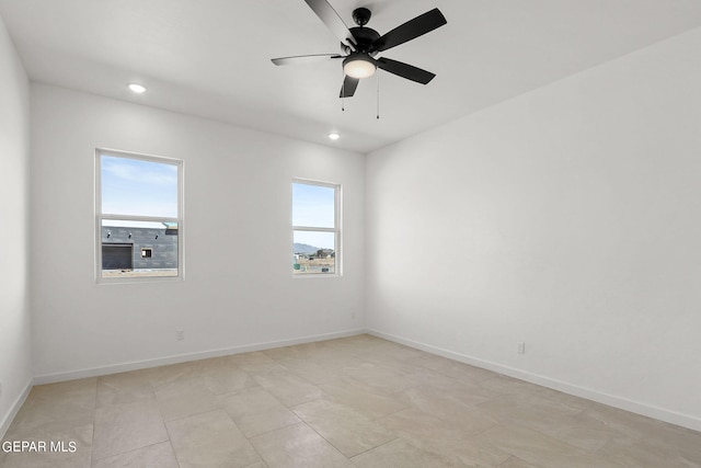 unfurnished room featuring light tile patterned floors, a healthy amount of sunlight, and ceiling fan