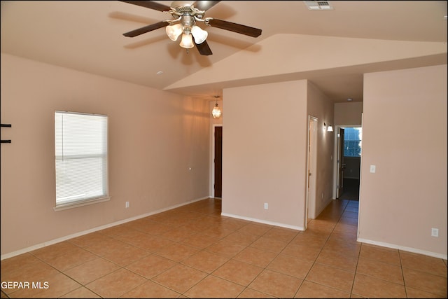 empty room with light tile patterned floors, ceiling fan, and lofted ceiling